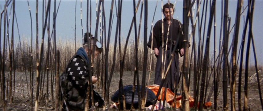Lone Wolf and Cub: White Heaven in Hell (1974) movie still: wide — An open field populated by charred, vertical stalks of burnt vegetation. A…