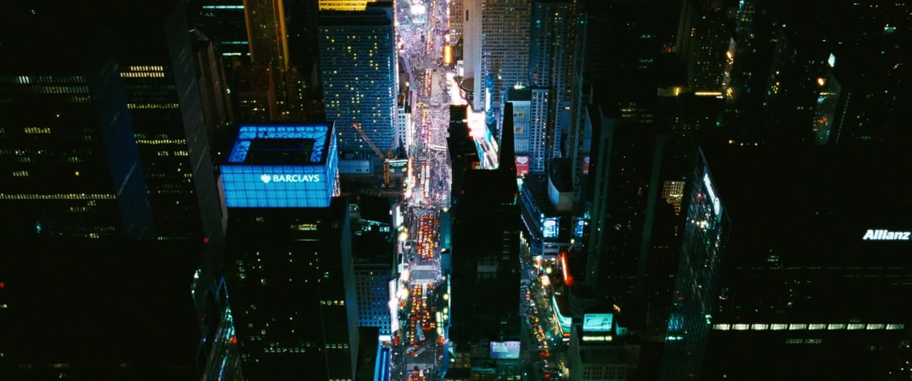 The Death and Life of John F. Donovan (2018) movie still: establishing — A dense urban grid of skyscrapers is viewed from a high aerial perspective…