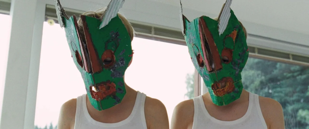 Goodnight Mommy (2014) movie still: medium — A sunlit room features large windows showing trees in the background. Two children stand side-by-side…