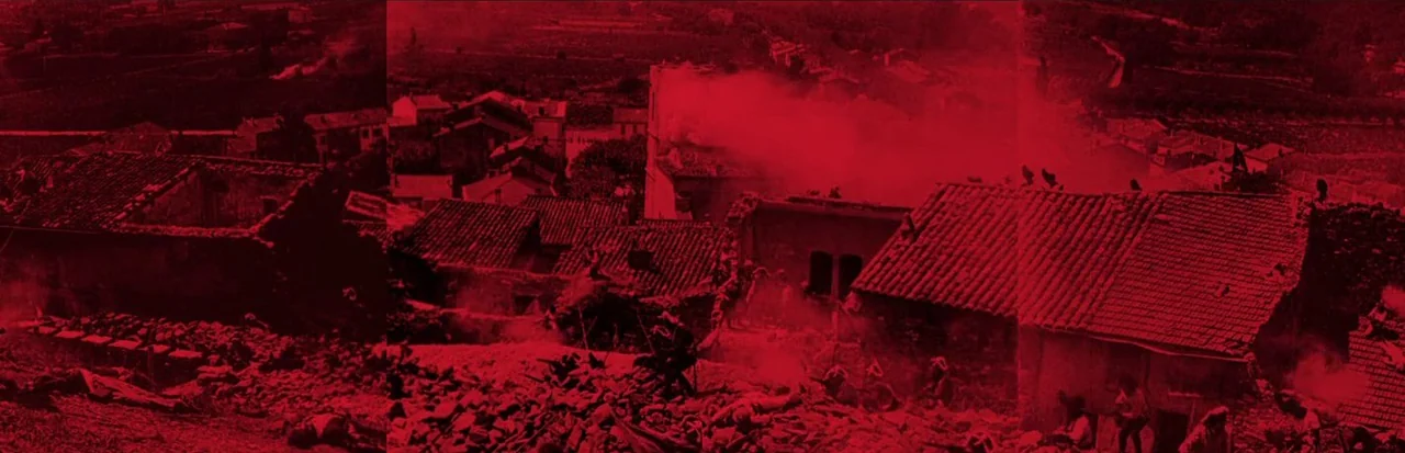 Napoleon (1927) movie still: establishing — A war-torn village features destroyed stone houses with crumbling roofs and billowing smoke plumes.…