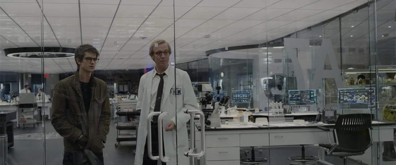 The Amazing Spider-Man (2012) movie still: medium — A modern, sterile scientific laboratory is enclosed by glass walls and white metallic accents. A…