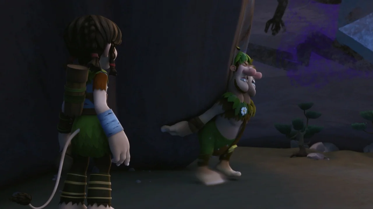 Troll: The Tale of a Tail (2018) movie still: medium — A dark outdoor space features a large boulder on a flat sandy ground. A small creature hides…