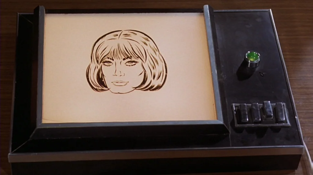 Danger Diabolik (1968) movie still: closeup — A vintage 1960s light table sits on a dark brown wooden desk surface. The device features a central…