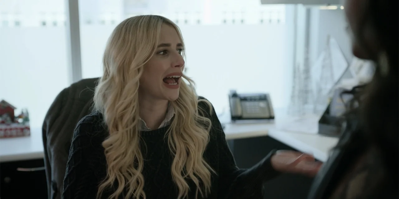 About Fate (2022) movie still: medium — A contemporary office space with a blurred window background and a desktop phone. A blonde woman in a dark…