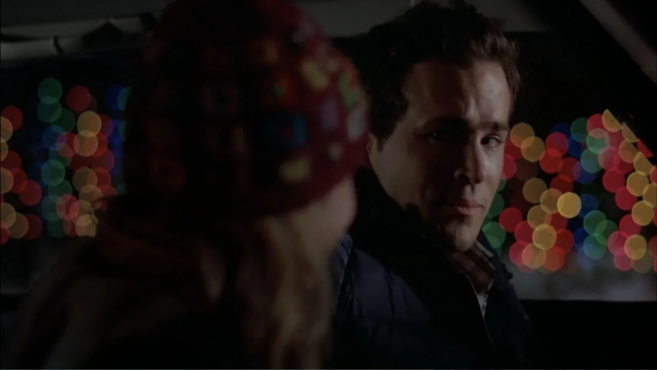 Just Friends (2005) movie still: medium — Inside a vehicle at night with blurred colorful city lights visible through the window. A man sits in the…