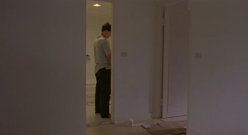 Yi-Yi (A One and A Two) (2000) movie still: wide — A minimalist corridor in a residential space features white walls and a light-colored floor. A…