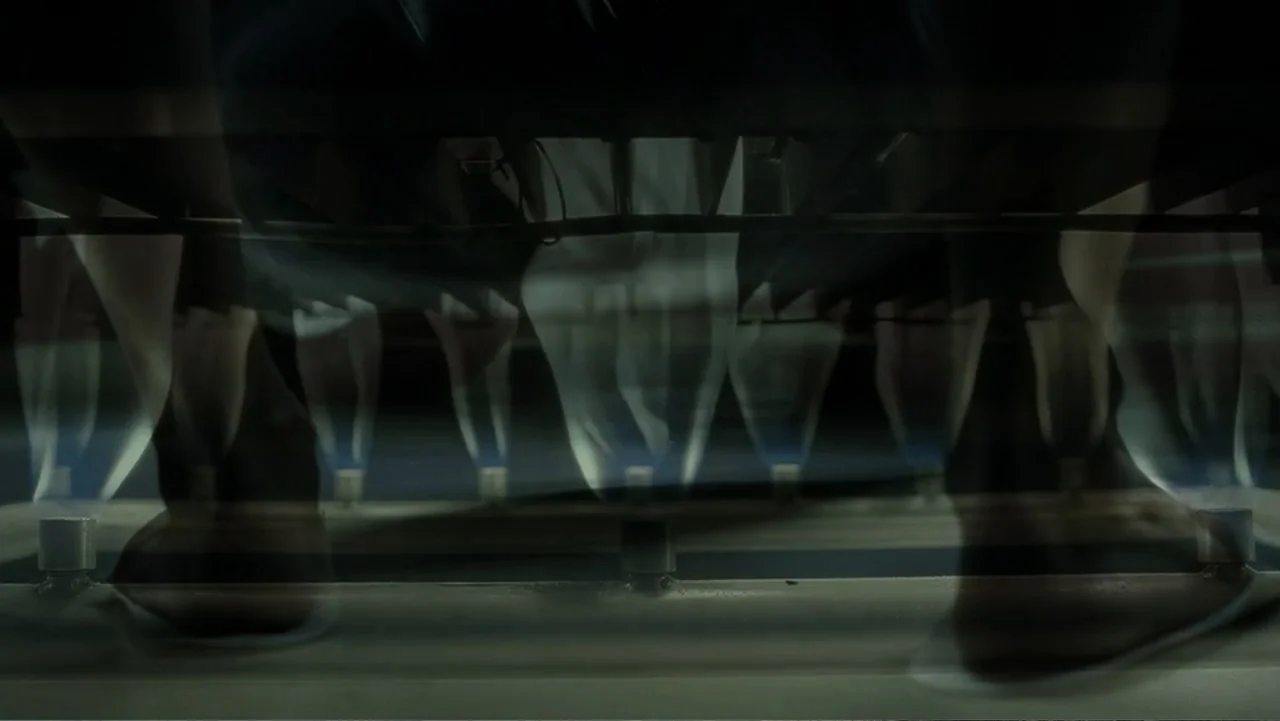 Mr. Brooks (2007) movie still: closeup — A dark interior scene shows multiple small gas flames burning on a stovetop. The metal grate of the stove…