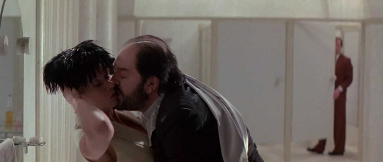 The Cook, The Thief, His Wife & Her Lover (1989) movie still: medium — A stark, minimalist all-white bathroom with several doorways leading into the…