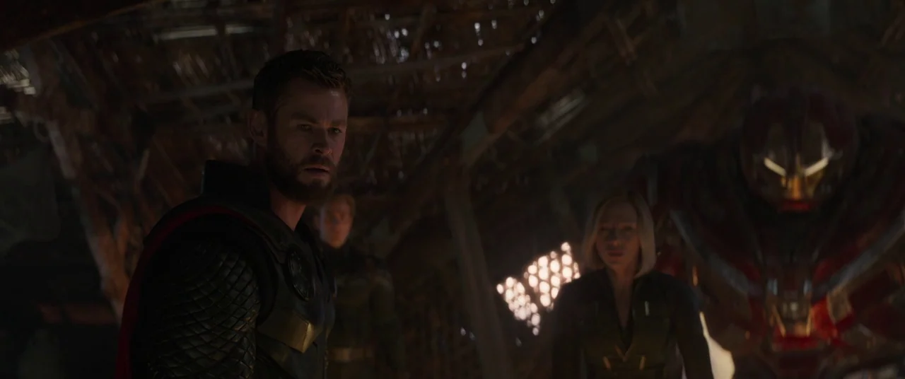 Avengers: Endgame (2019) movie still: medium — A dark wooden structure with slatted walls and light filtering through a geometric opening. Three…