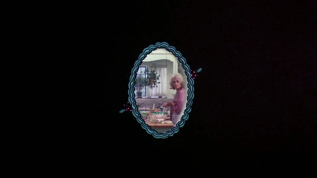 Creepshow (1982) movie still: wide — An oval-shaped vignette shows an older woman standing in a room with a window. The subject is positioned behind…