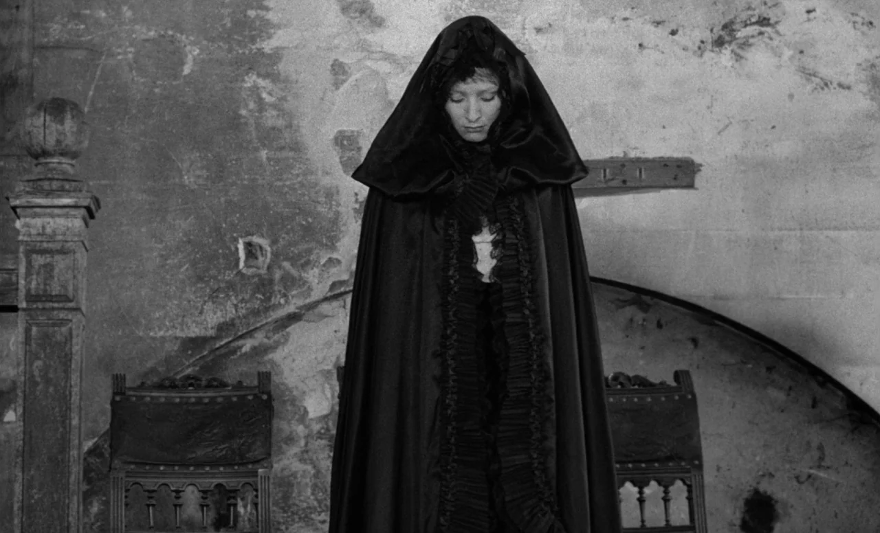 Goto, Island of Love (1969) movie still: fullbody — An interior space features a weathered stone wall with irregular stains and textures. A woman in…