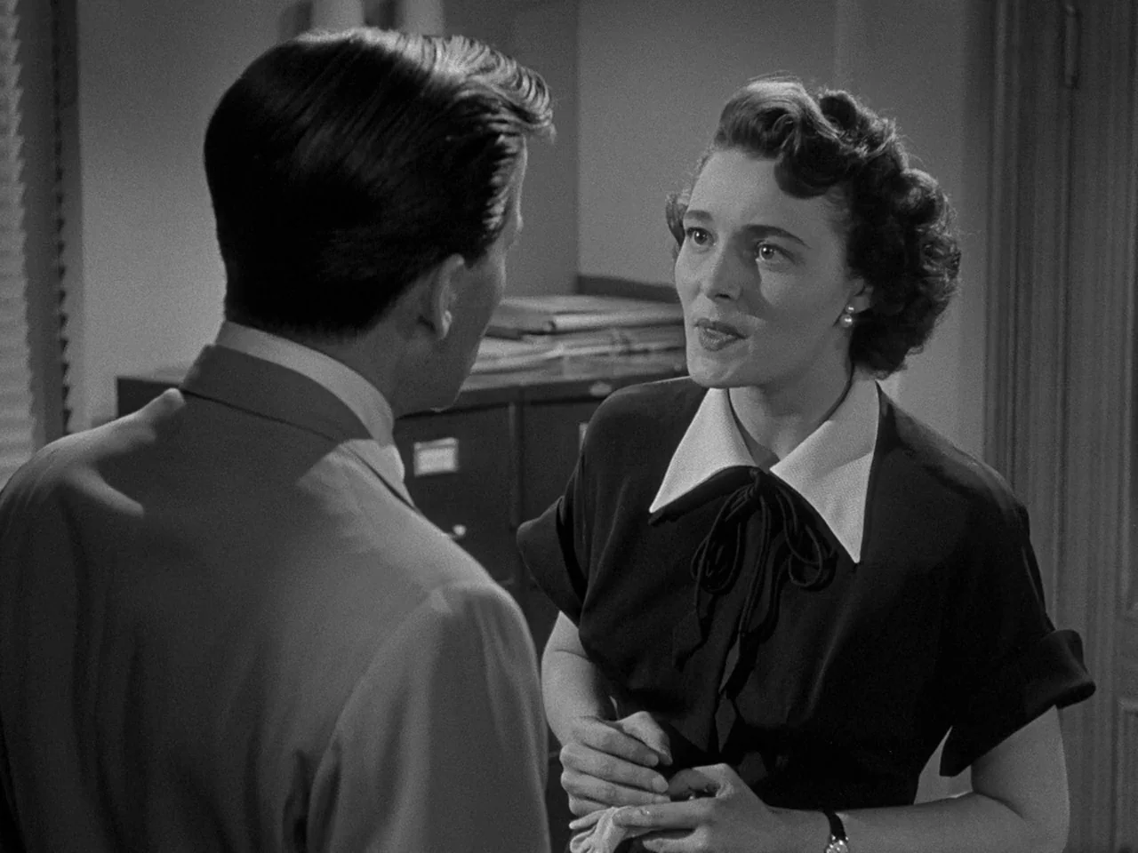 The Day the Earth Stood Still (1951) movie still: medium — An office interior features metal filing cabinets against a wall and plain wooden…