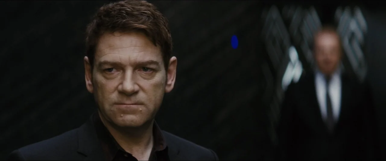 Jack Ryan: Shadow Recruit (2014) movie still: medium — A dark, modern hallway with textured black walls features a foreground subject and background…