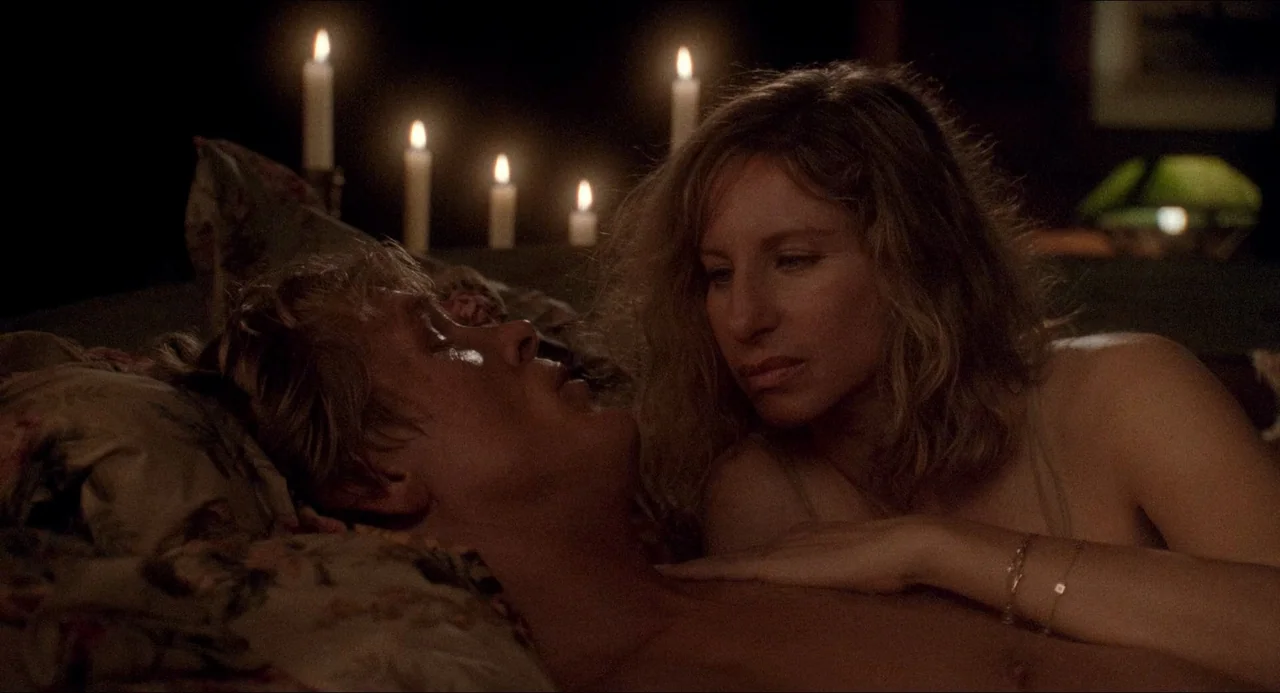 The Prince of Tides (1991) movie still: medium — A dimly lit bedroom features floral-patterned bedding and several lit taper candles. A woman looks…