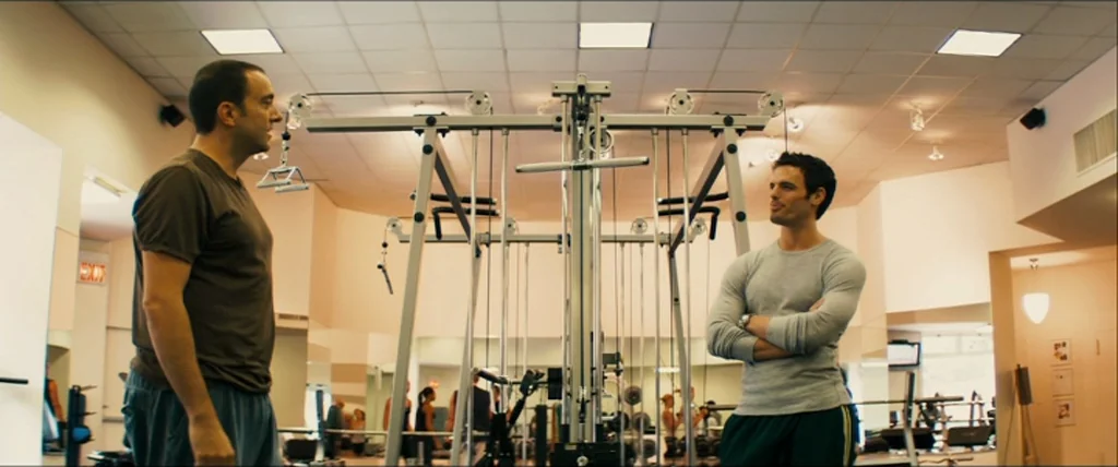 The Girlfriend Experience (2009) movie still: medium — A spacious, well-lit fitness center contains a large multi-station cable exercise machine.…
