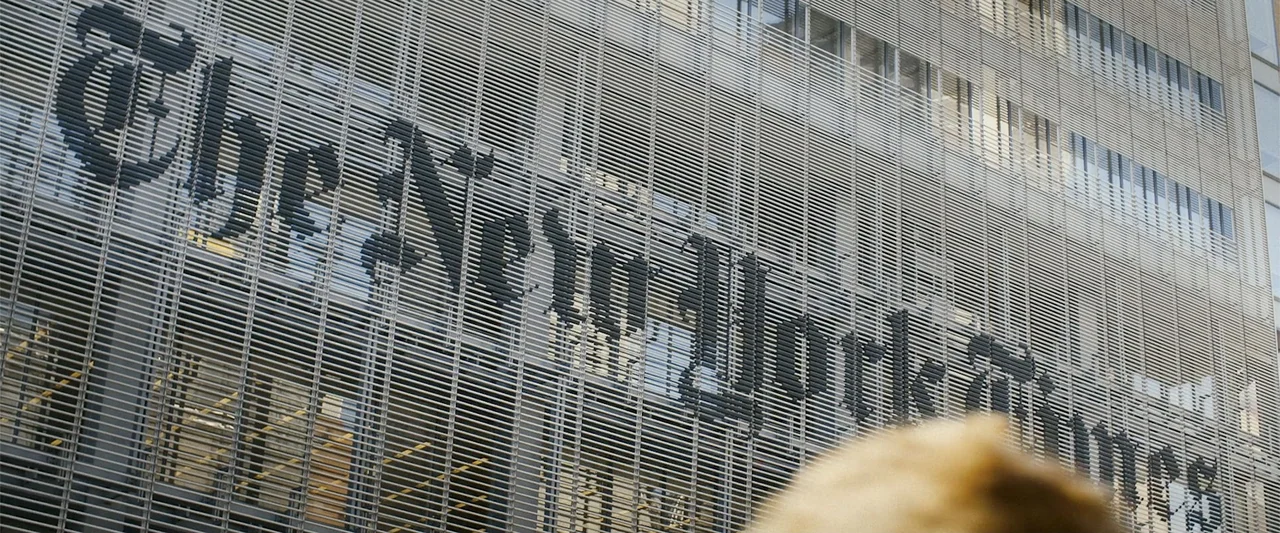 The Kleptocrats (2018) movie still: medium — The exterior glass wall of The New York Times building features horizontal metallic louvers. The…