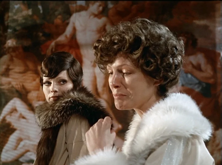 The Bitter Tears Of Petra Von Kant (1972) movie still: medium — Two women stand in front of a large Renaissance-style oil painting on a wall. The…