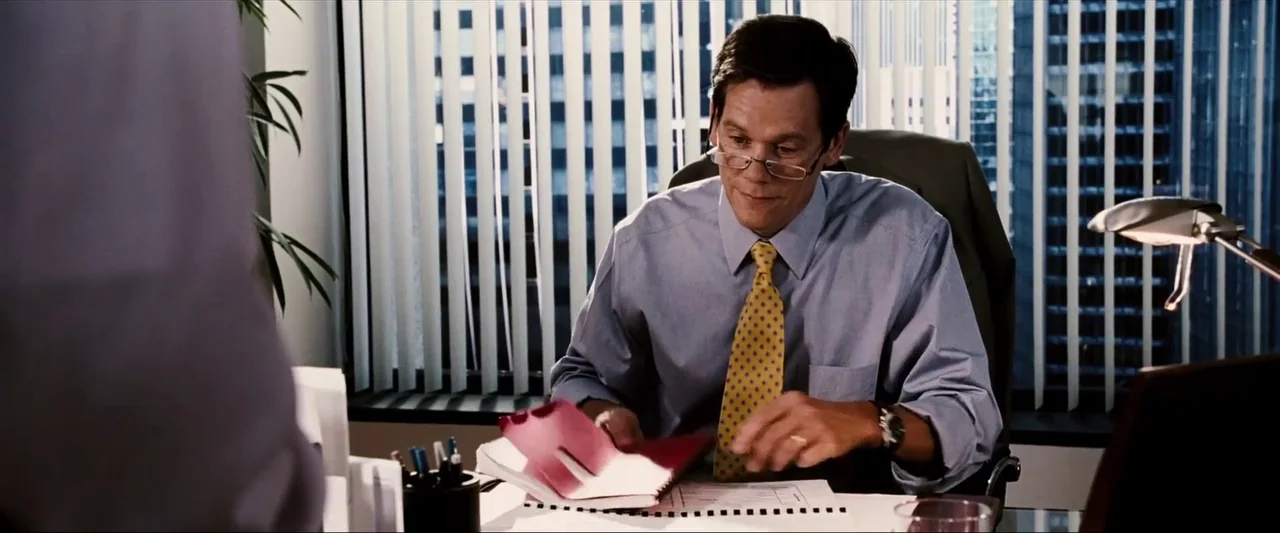Death Sentence (2007) movie still: medium — A corporate office environment features vertical window blinds looking out onto a city skyline. A man in…