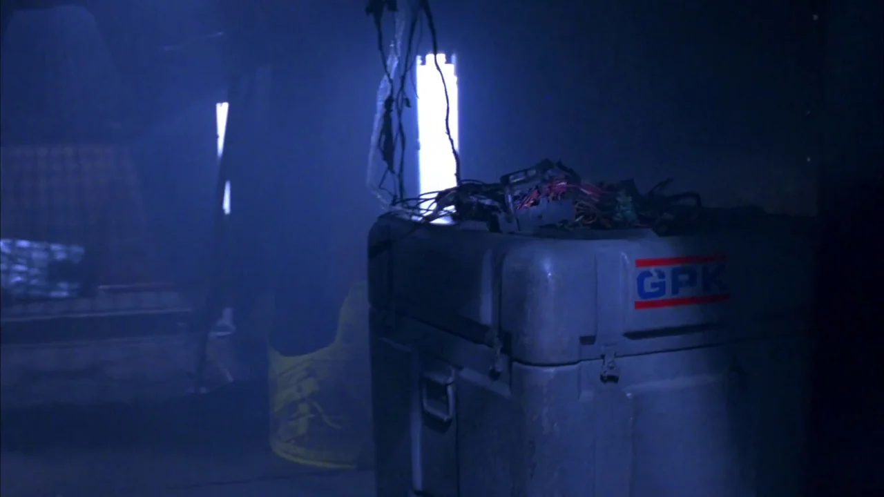 Hellraiser: Bloodline (1996) movie still: medium — A dark, smoke-filled industrial space features a large storage container with electrical…