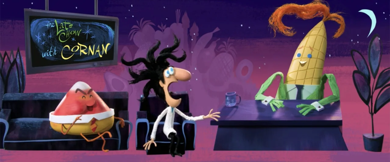 Cloudy with a Chance of Meatballs 2 (2013) movie still: medium — A stylized television studio set features a purple backdrop with oversized fruit…