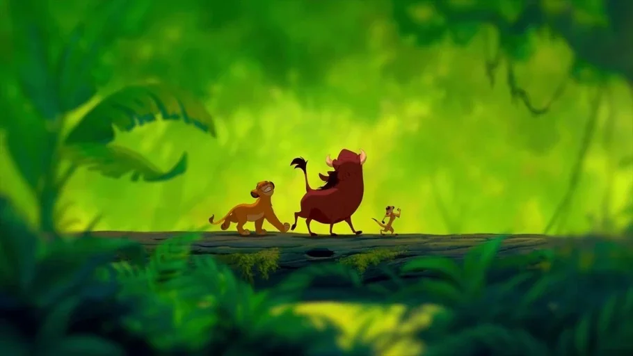 The Lion King (1994) movie still: wide — A dense green jungle surrounds a large fallen log that acts as a bridge. A lion cub, a warthog, and a…