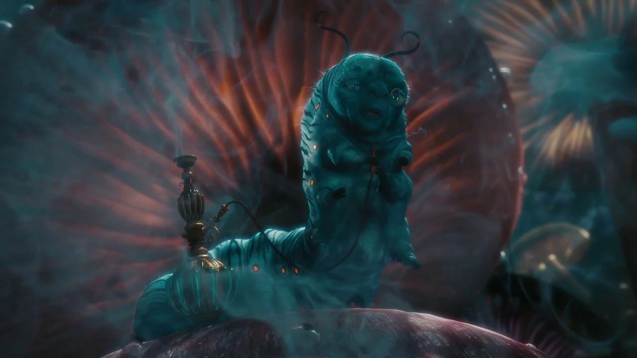 Alice in Wonderland (2010) movie still: medium — A giant blue caterpillar sits atop a massive red-gilled mushroom in a dark environment. The…