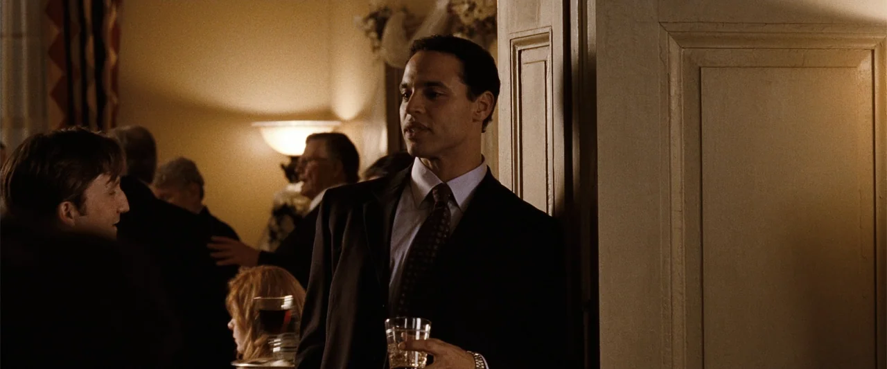 Ghosts of Girlfriends Past (2009) movie still: medium — A formal event takes place in an upscale hall with warm wall lighting. A man stands near a…