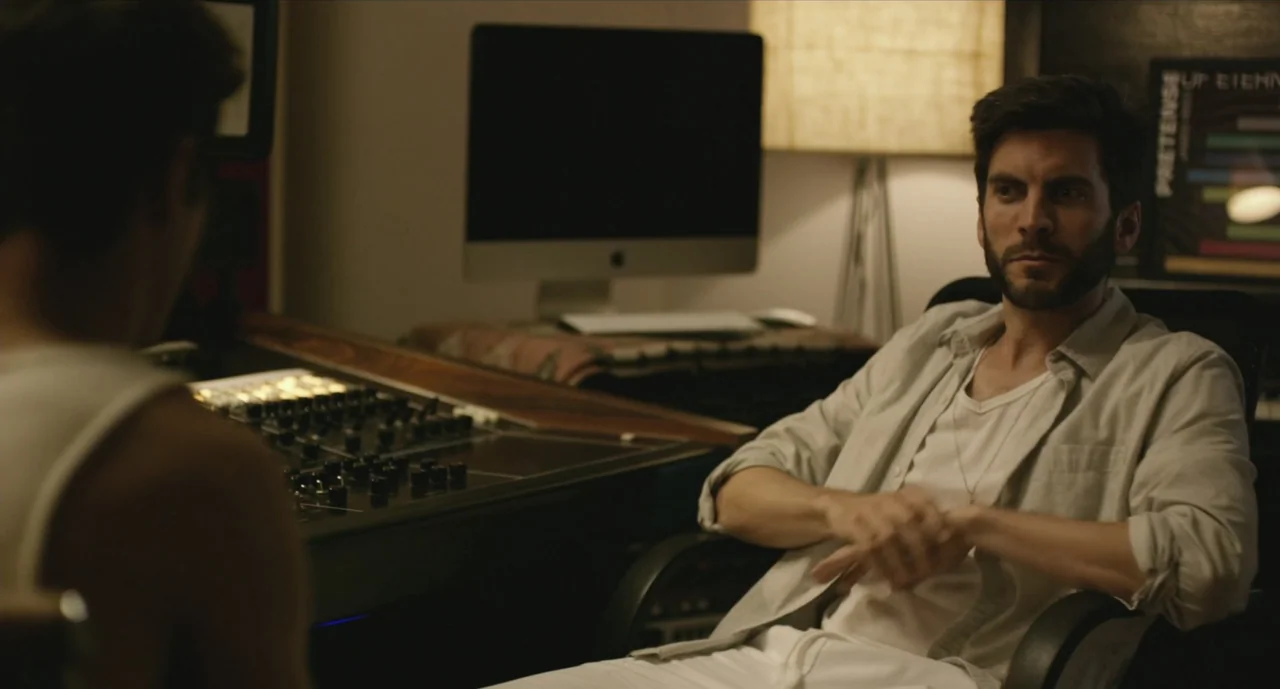 We Are Your Friends (2015) movie still: medium — A recording studio workspace with audio equipment and a computer monitor visible. A man sits in a…