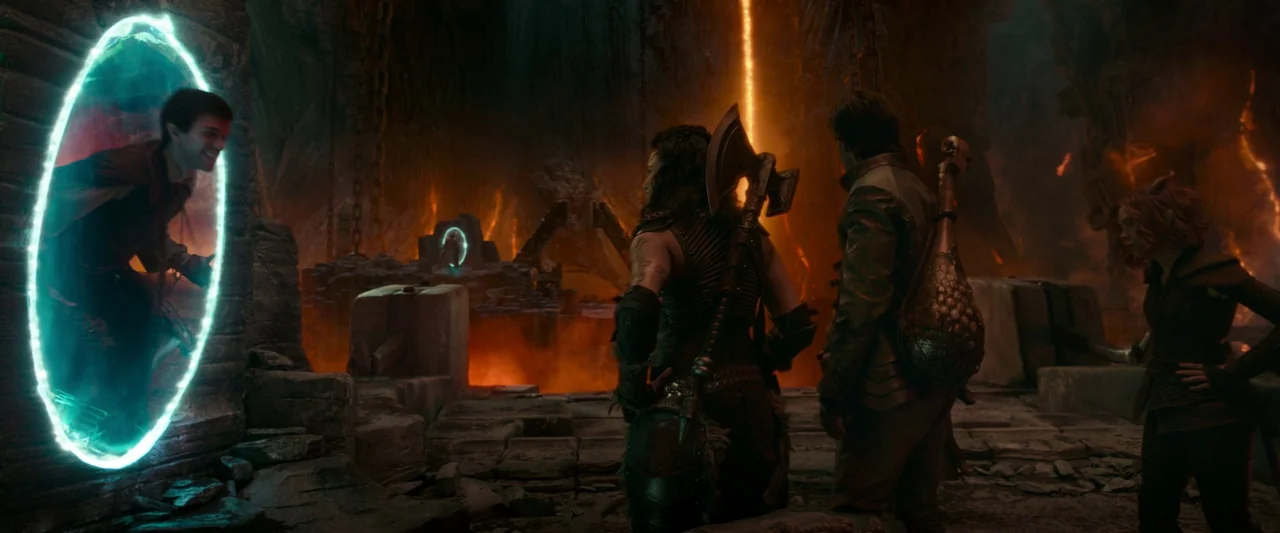 Dungeons & Dragons: Honor Among Thieves (2023) movie still: wide — A dark rocky cavern contains large pits of glowing magma and stone platforms.…