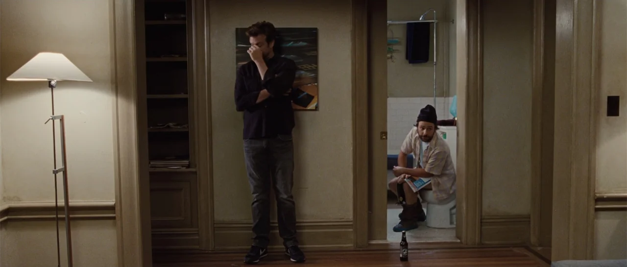 Going the Distance (2010) movie still: fullbody — A domestic apartment interior shows a hallway transitioning into a tiled bathroom area. One man…