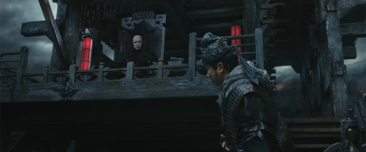 Along with the Gods: The Two Worlds (2017) movie still: medium — An elevated wooden balcony structure features dark ornate carvings under a stormy…