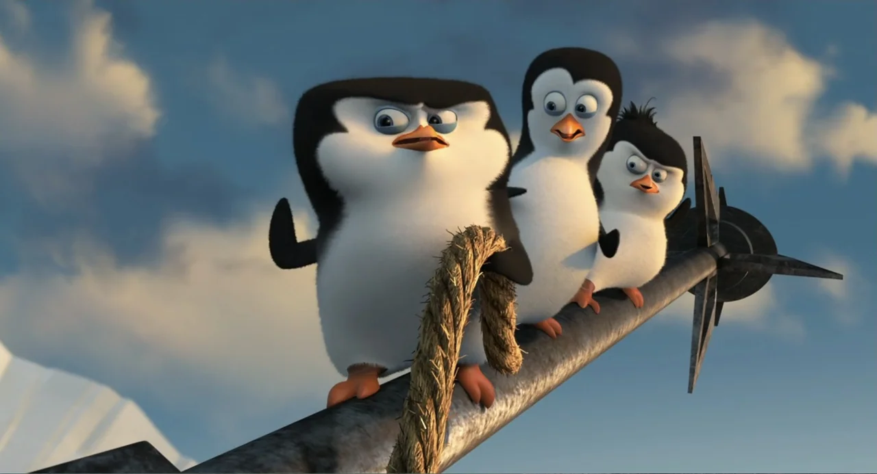 Penguins of Madagascar (2014) movie still: medium — Three cartoon penguins balance on a long metal pole under a clear blue sky. The penguins look in…