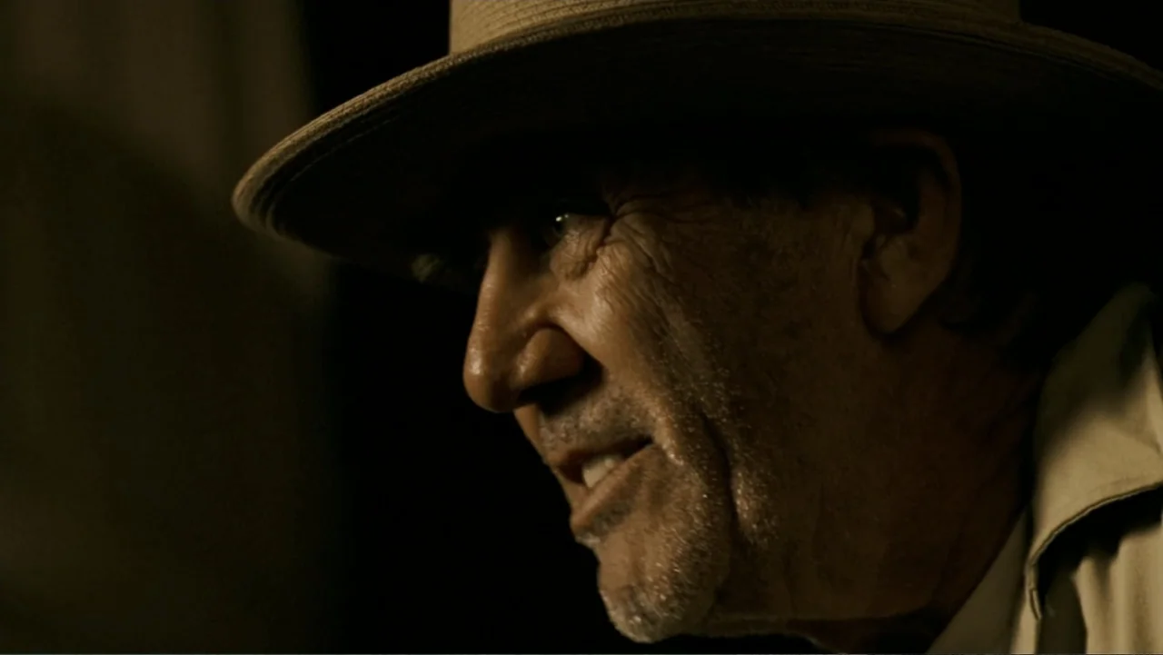 The Texas Chainsaw Massacre: The Beginning (2006) movie still: closeup — A dark, dimly lit interior space serves as the background for a man's face.…