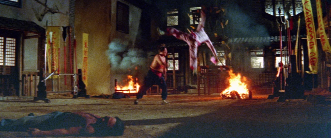 Encounter of the Spooky Kind (1980) movie still: wide — A traditional stone courtyard features burning fire pits and hanging ceremonial banners at…