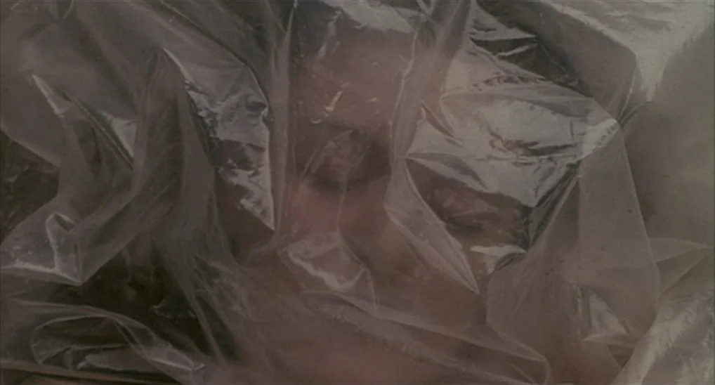 Twin Peaks: Fire Walk With Me (1992) movie still: closeup — A face is partially covered by a layer of thin, wrinkled, transparent plastic sheeting.…