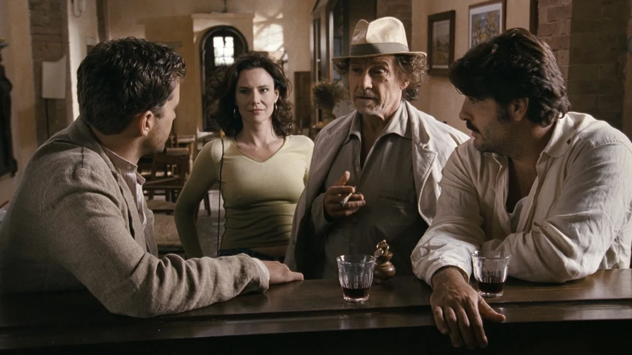 Shadows in the Sun (2005) movie still: medium — A rustic bar with stone walls and wooden furniture houses a social gathering. Four adults lean…