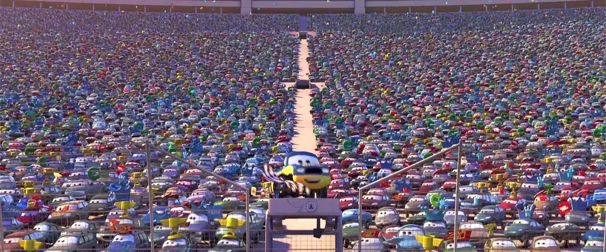 Cars (2006) movie still: wide — A massive outdoor sports stadium is packed with thousands of distinct car characters. A small yellow vehicle moves…