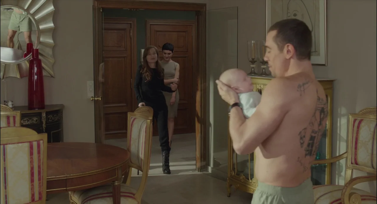Abuse of Weakness (2013) movie still: medium — An opulent dining room features a round table and a large decorative wall mirror. A shirtless man…