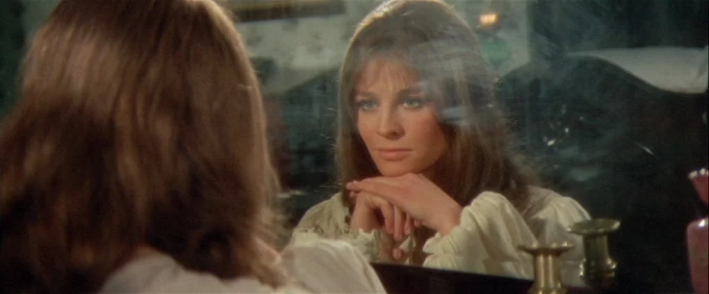 Far from the Madding Crowd (1967) movie still: medium — A woman gazes at her own reflection in a large vanity mirror. She rests her chin on her…
