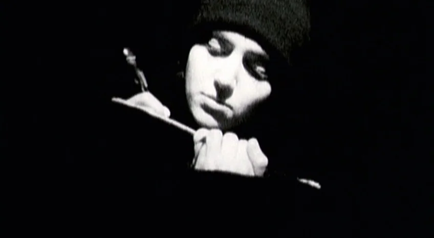 Brand Upon the Brain! (2006) movie still: closeup — A figure stands against a completely black background. A man writes with a pen while wearing a…