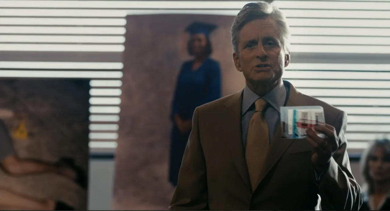 Beyond a Reasonable Doubt (2009) movie still: medium — An office interior features horizontal blinds covering a window with large photos displayed…