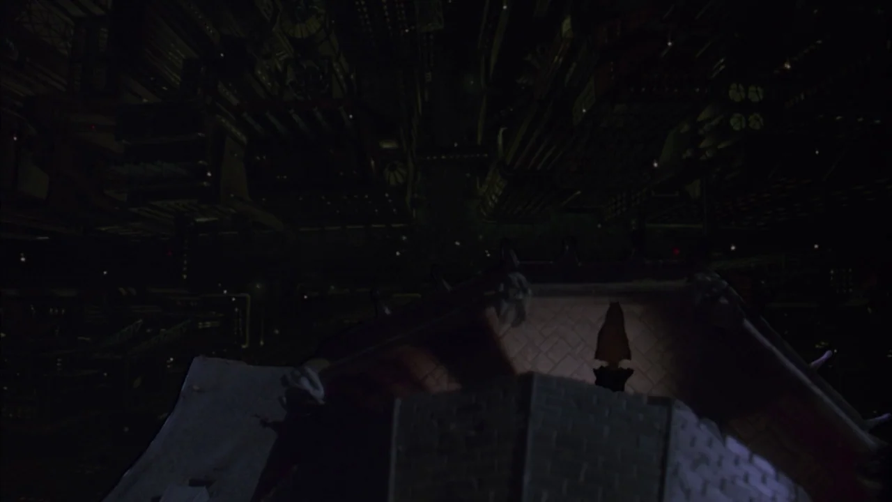 Batman (1989) movie still: establishing — A dark gothic rooftop sits in the foreground of a massive, shadowed industrial cityscape. The architecture…