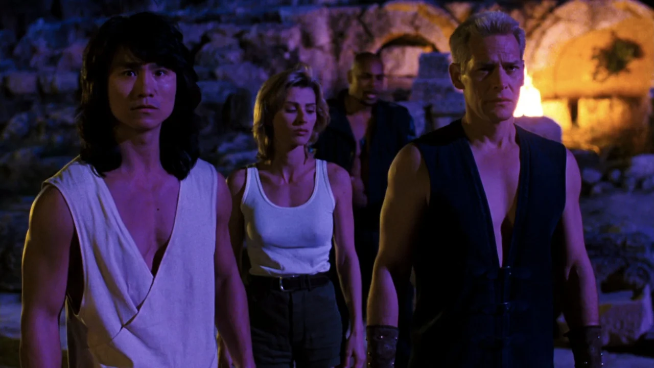 Mortal Kombat: Annihilation (1997) movie still: medium — A set of ancient stone ruins at night is illuminated by flickering firelight. Three people…