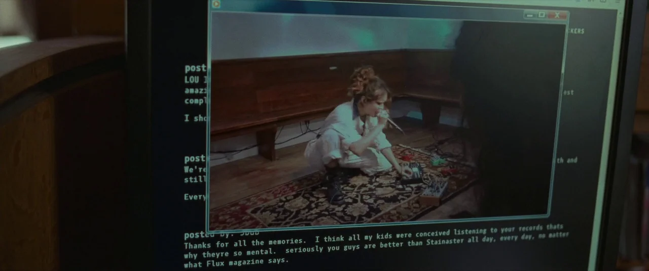 Sound of Metal (2019) movie still: medium — A computer screen displays a video window over a black interface with white text. The video inside shows…