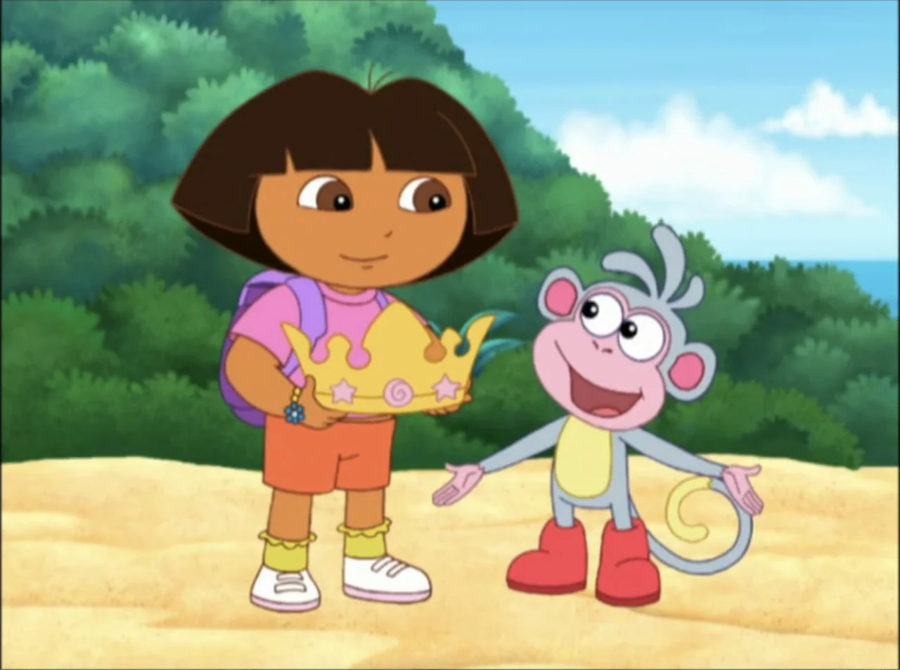 Dora the Explorer: Mermaid Adventures (2025) movie still: medium — A cartoon girl and a small monkey stand on a sandy beach. The girl presents a…