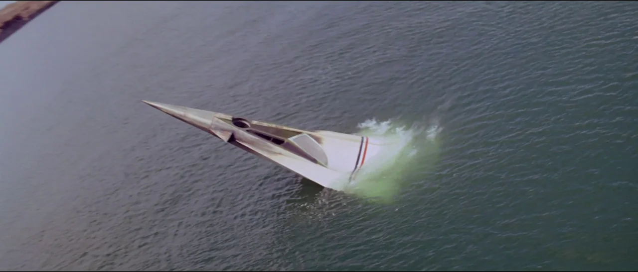 Planet of the Apes (1968) (1968) movie still: wide — A triangular shaped experimental craft sits low in the calm surface of a body of water. White…