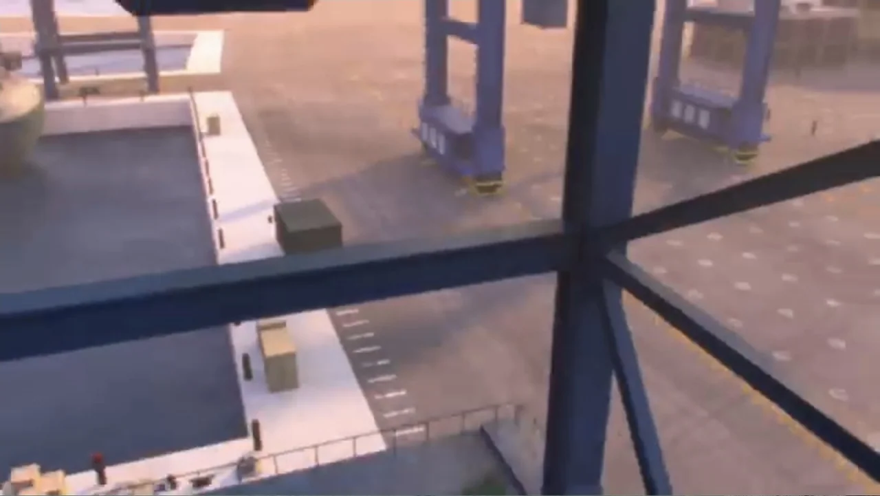 Max Steel: Team Turbo (2016) movie still: wide — An industrial shipping port view from an elevated steel observation platform at sunset. The frame…