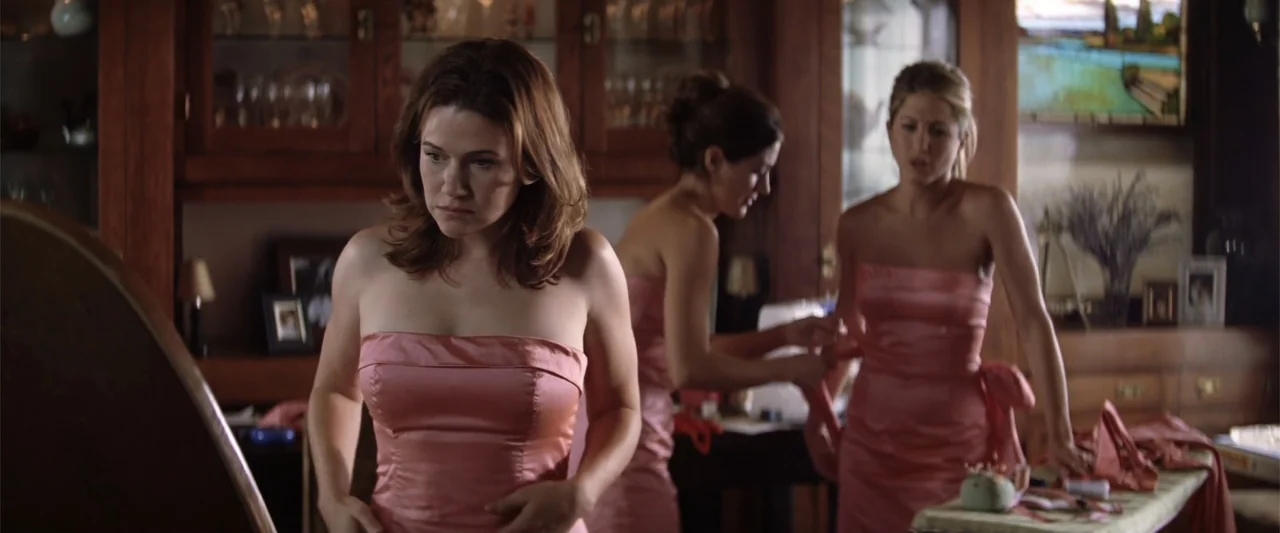 He's Just Not That Into You (2009) movie still: medium — A residential bedroom interior features wood-paneled walls and a glass display cabinet.…
