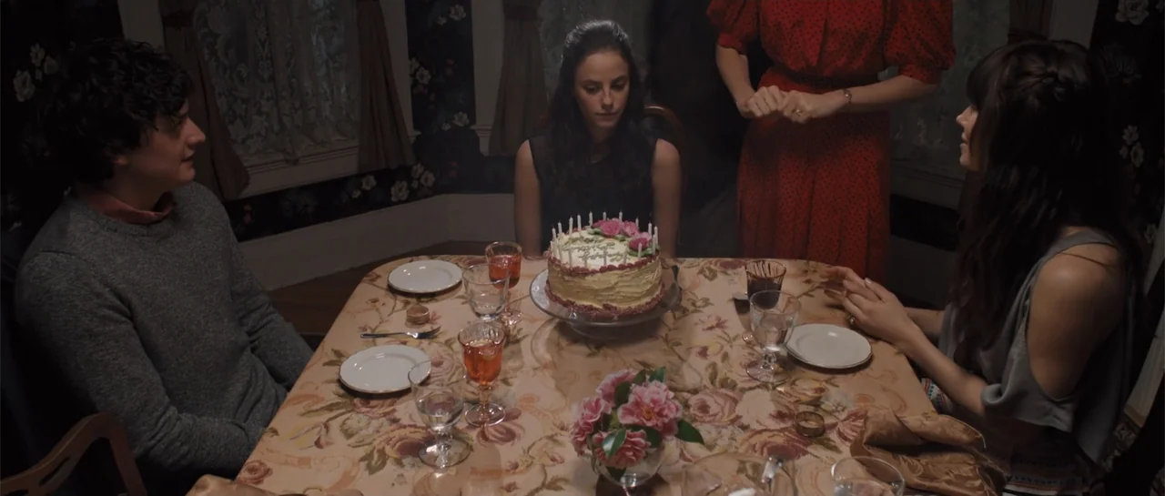 The Truth About Emanuel (2013) movie still: medium — A dining room with floral-patterned wallpaper and a table covered in a rose-printed cloth.…