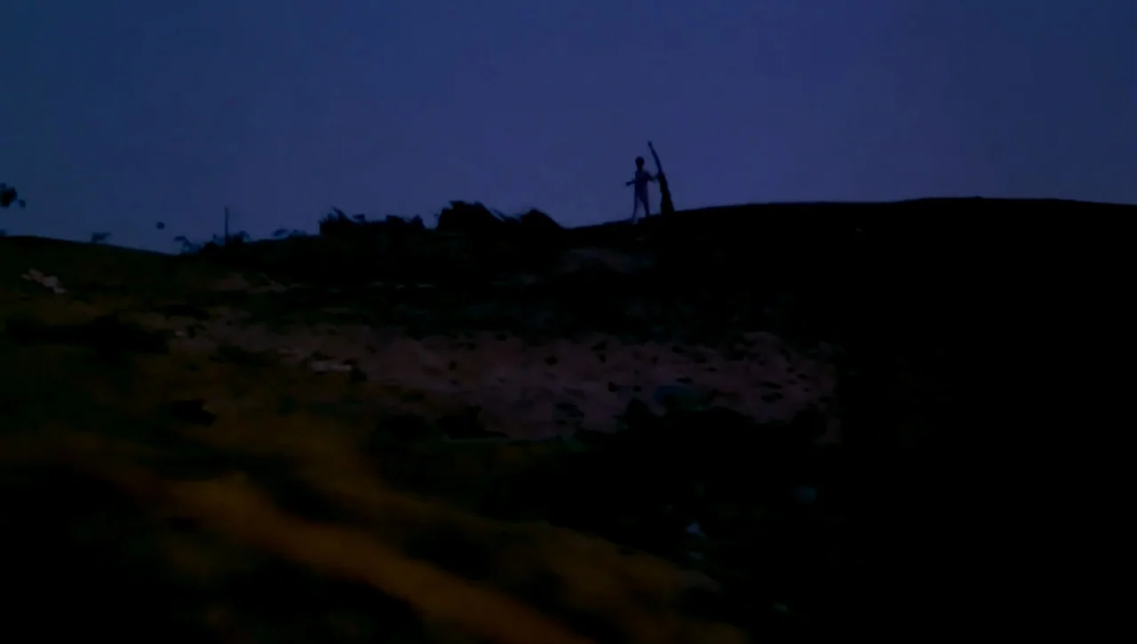 The Return of the Prodigal Son (1978) movie still: wide — A dark, hilly landscape is set against a deep blue evening sky. A small, silhouetted…